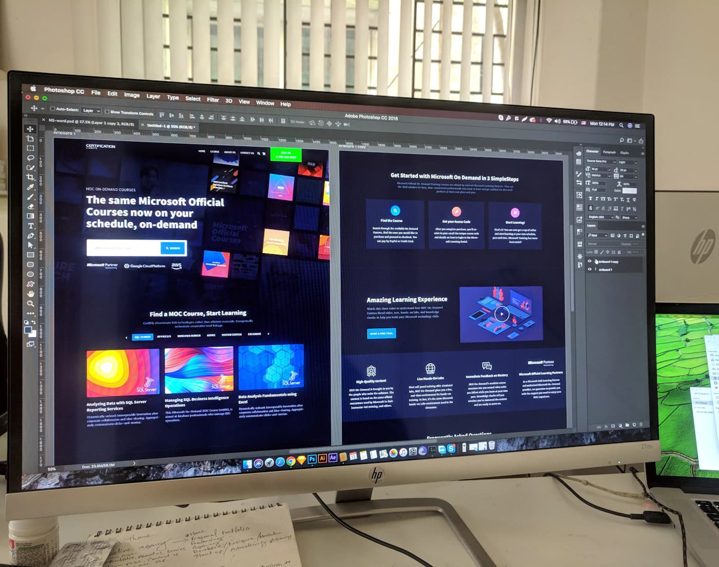 Designer refining a website layout in Photoshop on a large desktop monitor