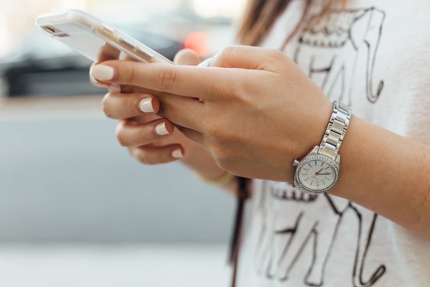 Person browsing a website on a smartphone held in both hands